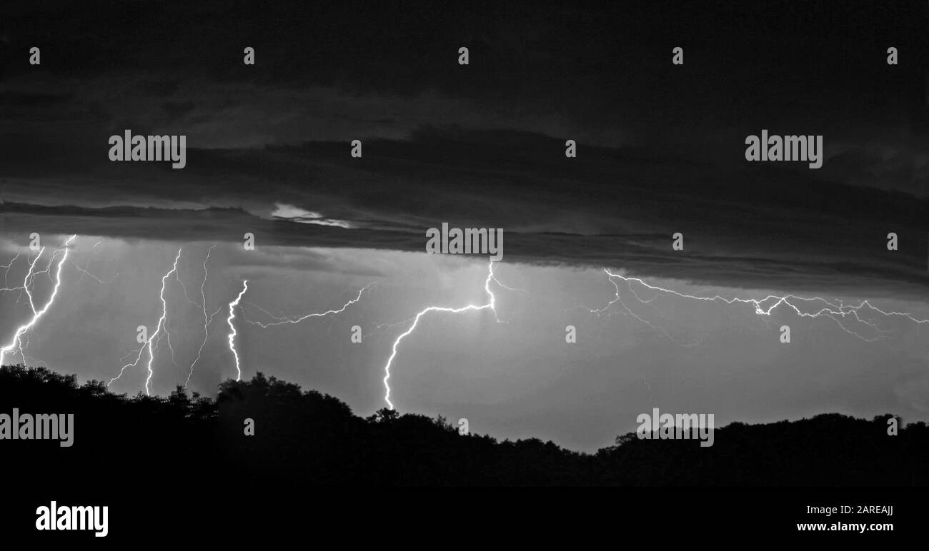 Grayscale shot of lightning that comes from a storm Stock Photo