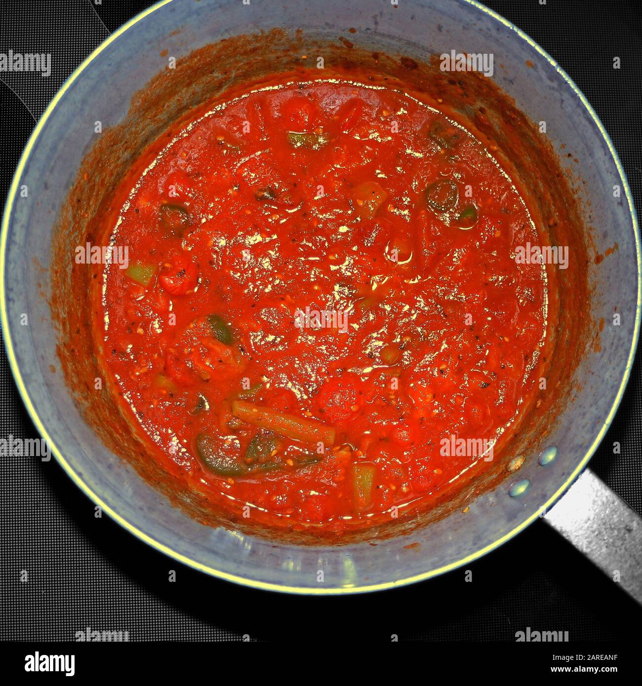 Aerial shot of a stewed tomato sauce with different spices of