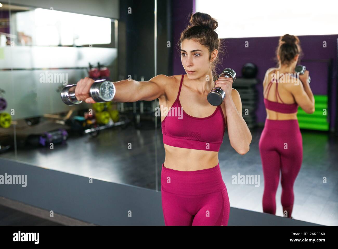 Sporty woman punching and boxing with dumbbells Stock Photo - Alamy