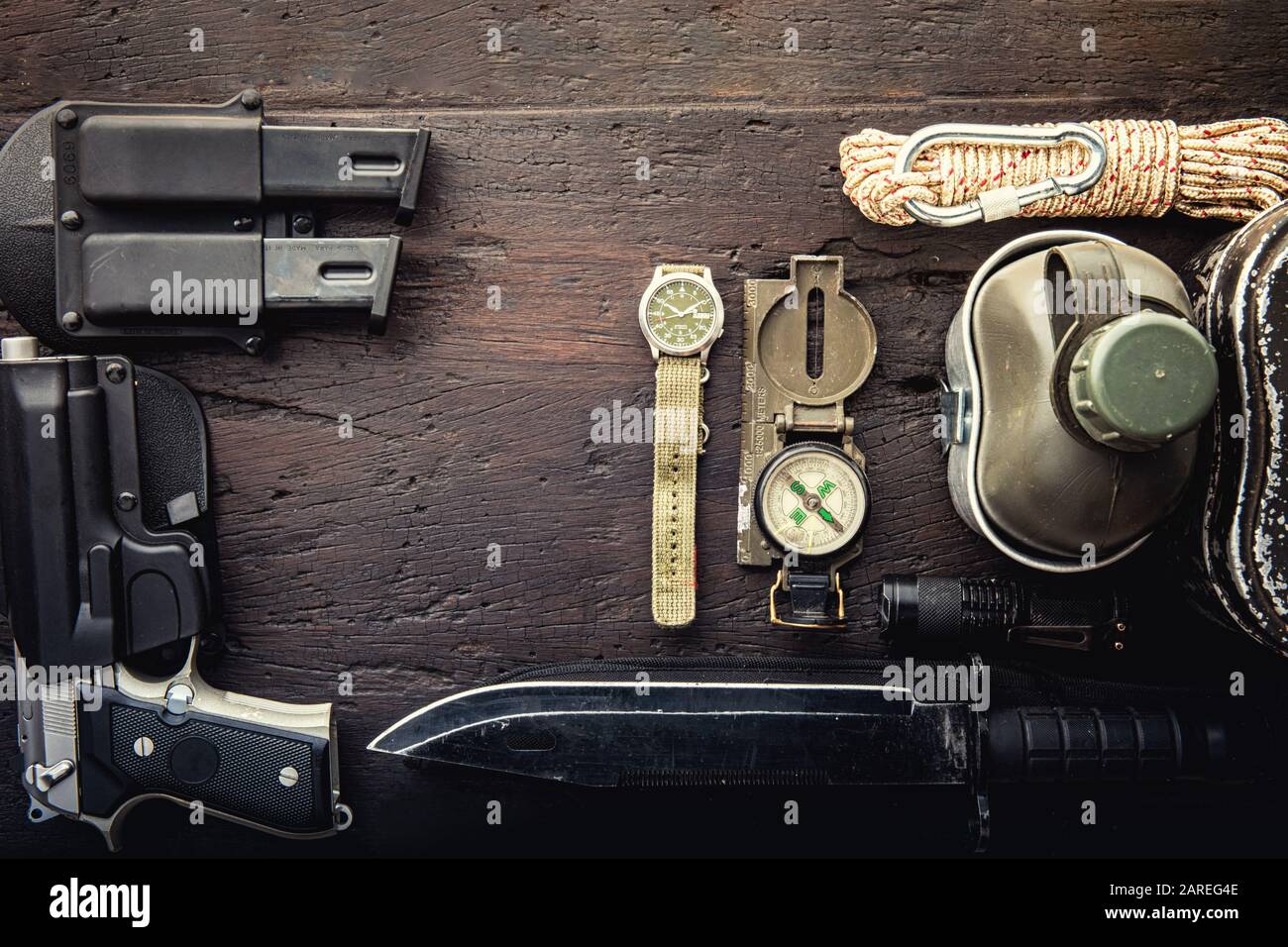 Military tactical equipment for the departure. Assortment of survival  hiking gear on wooden background. Top view - vintage film grain filter  effect st Stock Photo - Alamy
