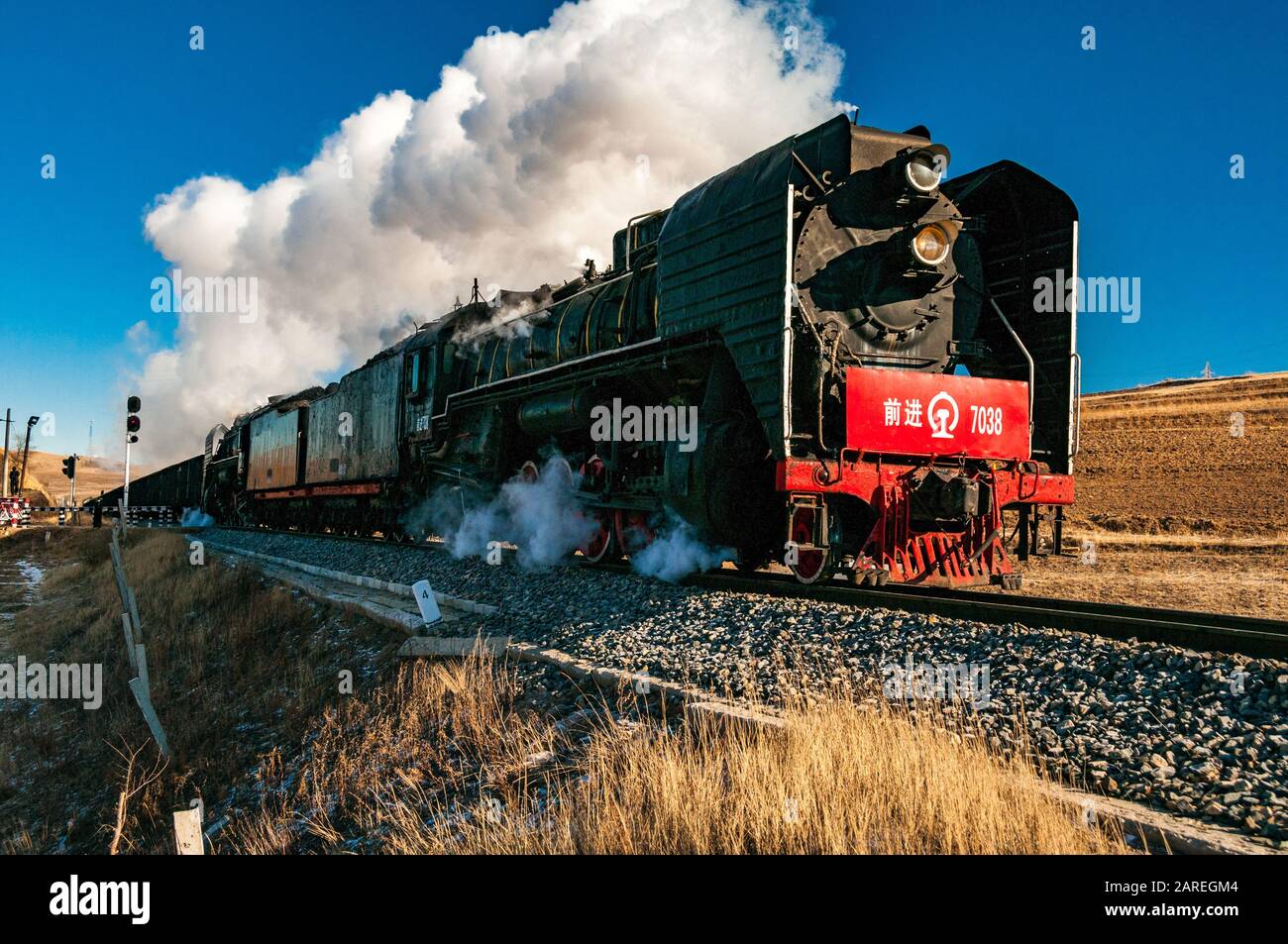 QJ 2-10-2 steam locomotives on the Jitong Railway, Inner Mongolia, China hauling wagons on the way to Jingpeng Station. Stock Photo