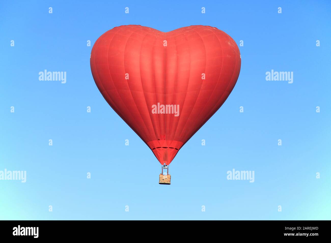 St. Valentine's day. The red heart in the blue sky. Flight on a hot air ...