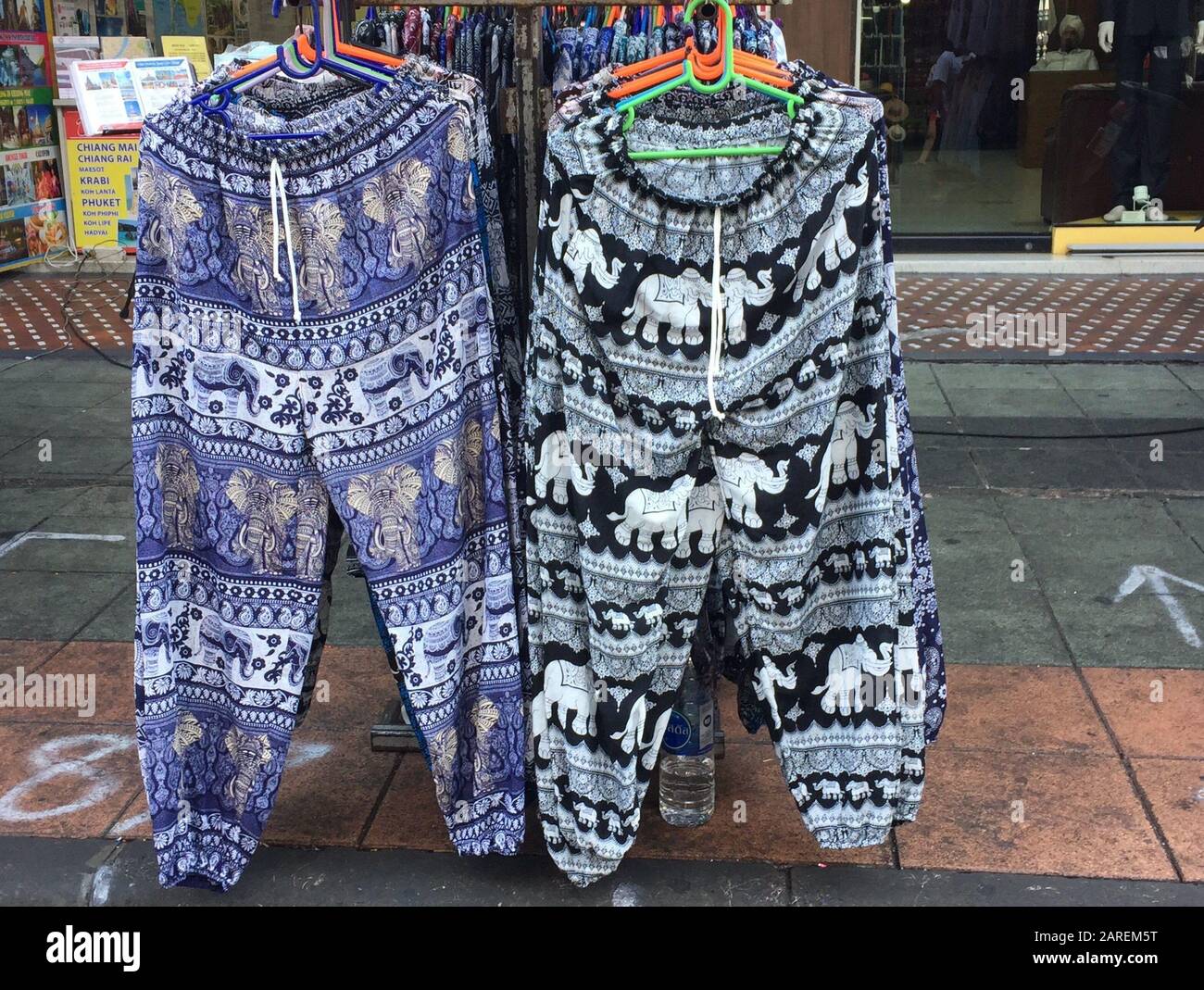 Bangkok, Thailand. 04th Jan, 2020. Two so-called elephant pants are hanging  from a coat stand on a street in Thailand's capital Bangkok. The wide, airy  trousers with wild elephant patterns are popular