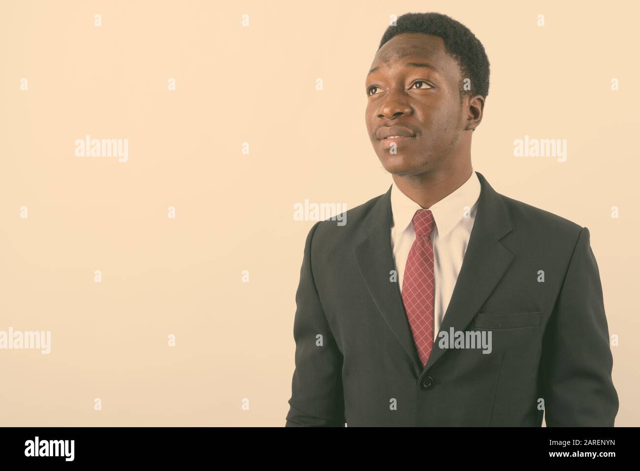Young handsome African businessman wearing suit against white ...