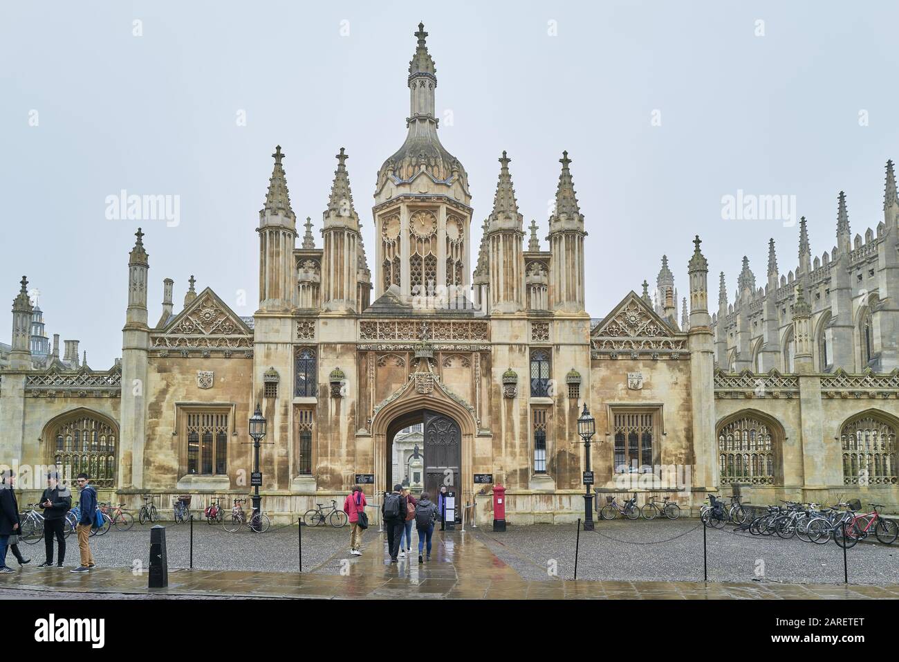 Ornate stone front facade and entrance to King's college, university of Cambridge, England, on a wet winter day. Stock Photo