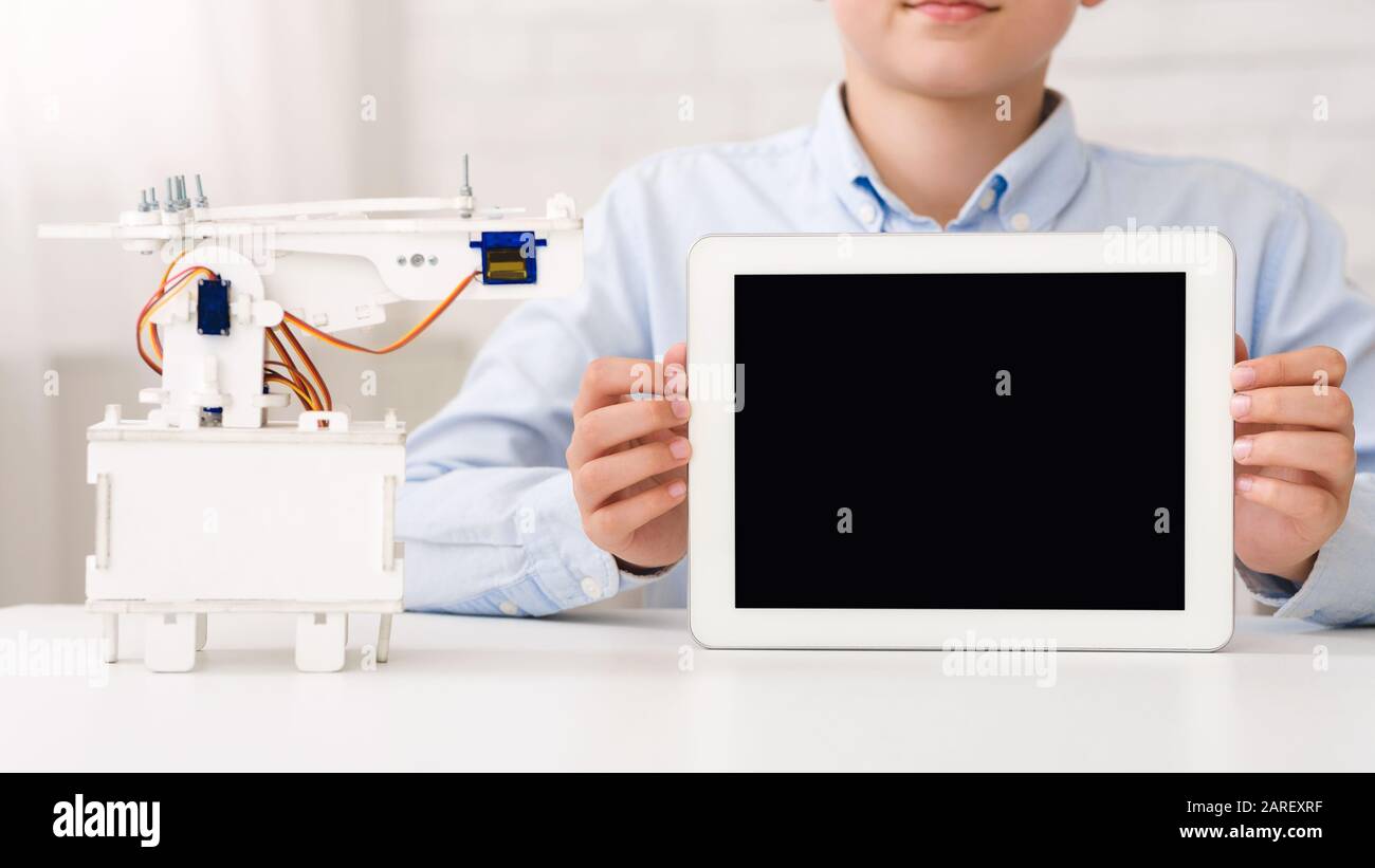 Mockup for advertisement. Boy holding tablet with blank screen Stock Photo