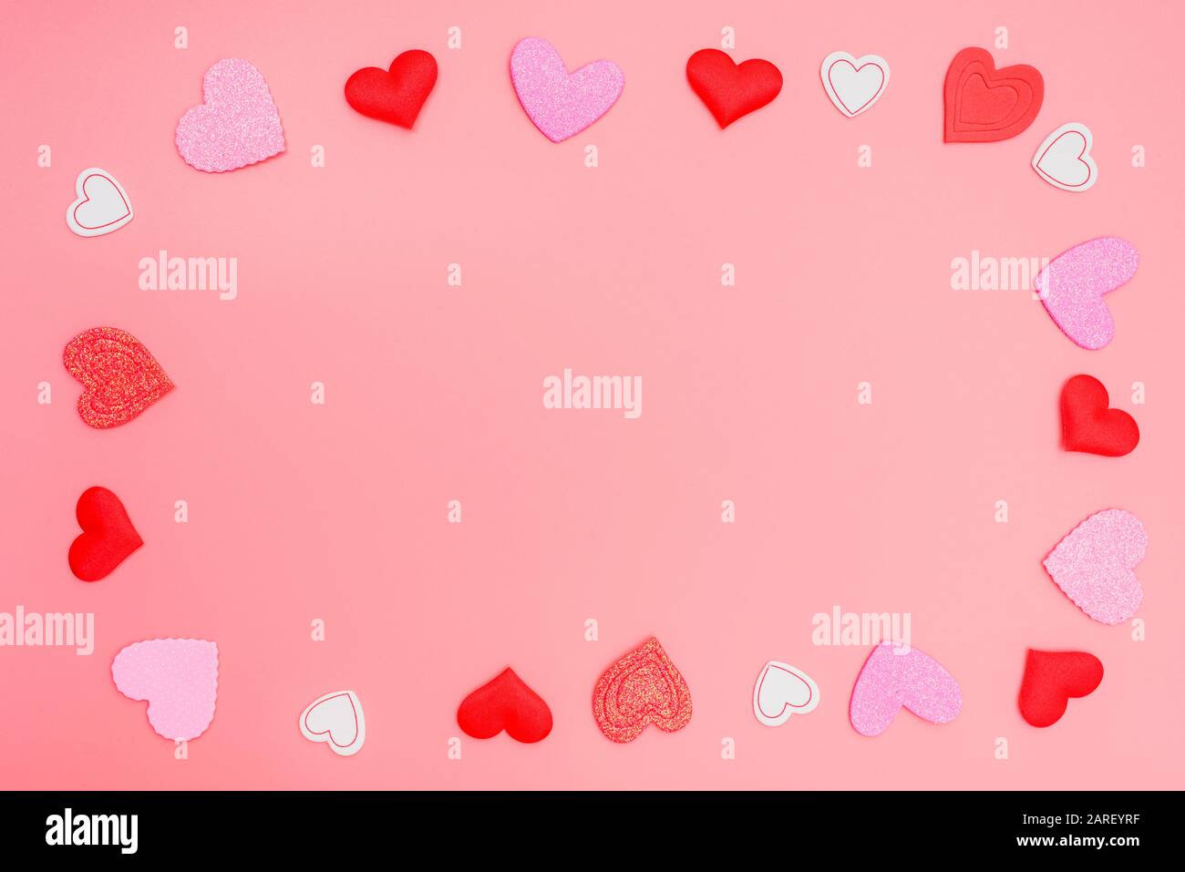Pink background framed with red hearts for romantic motives in ...