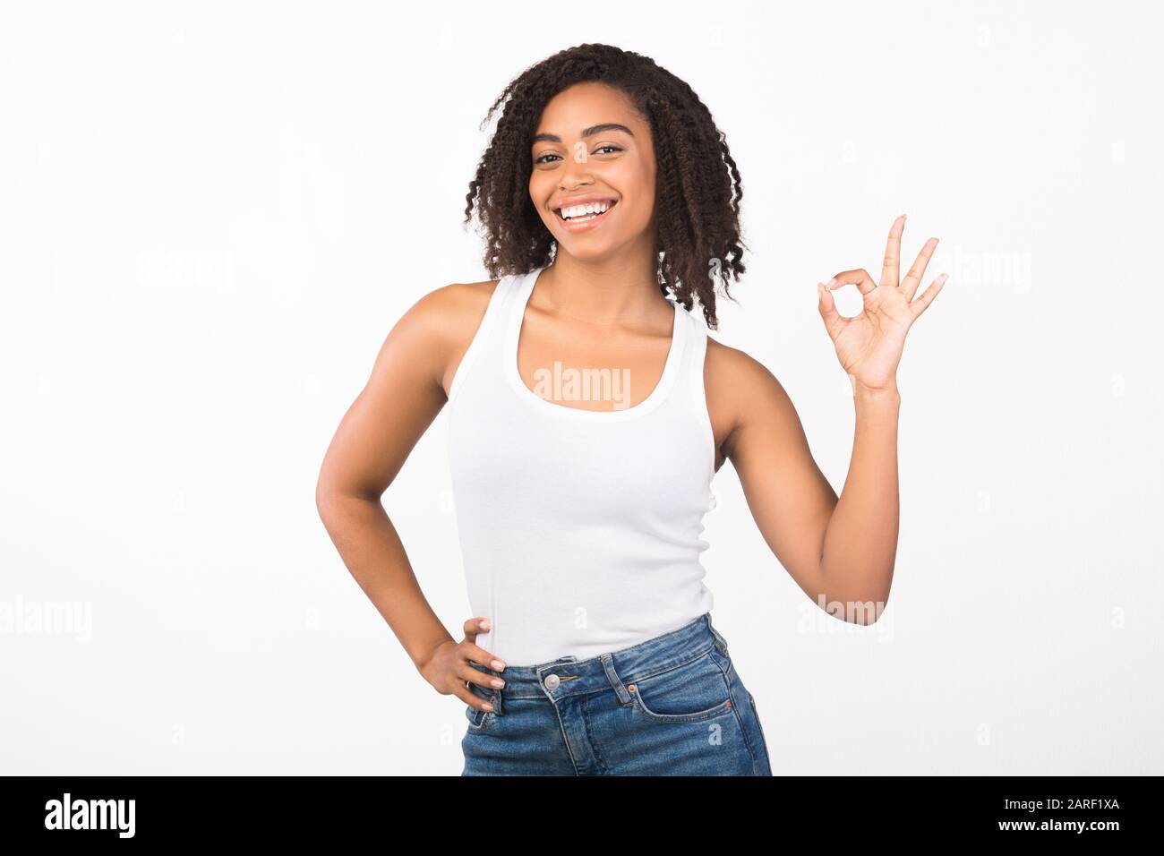 Happy african american girl showing ok sign gesture Stock Photo - Alamy