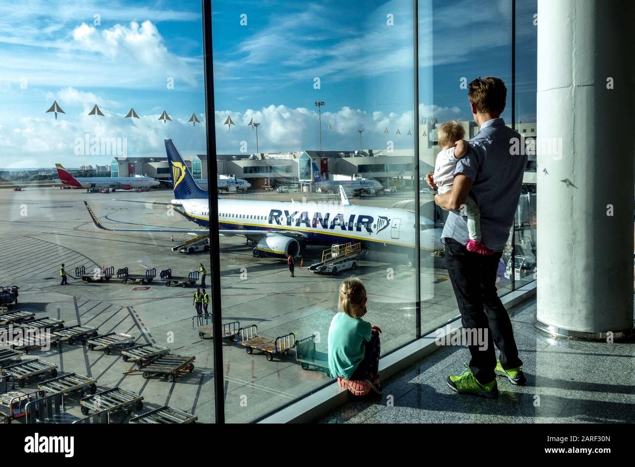 Waiting family at airport, man and kids watch planes on runway Airport Palma de Mallorca Stock Photo
