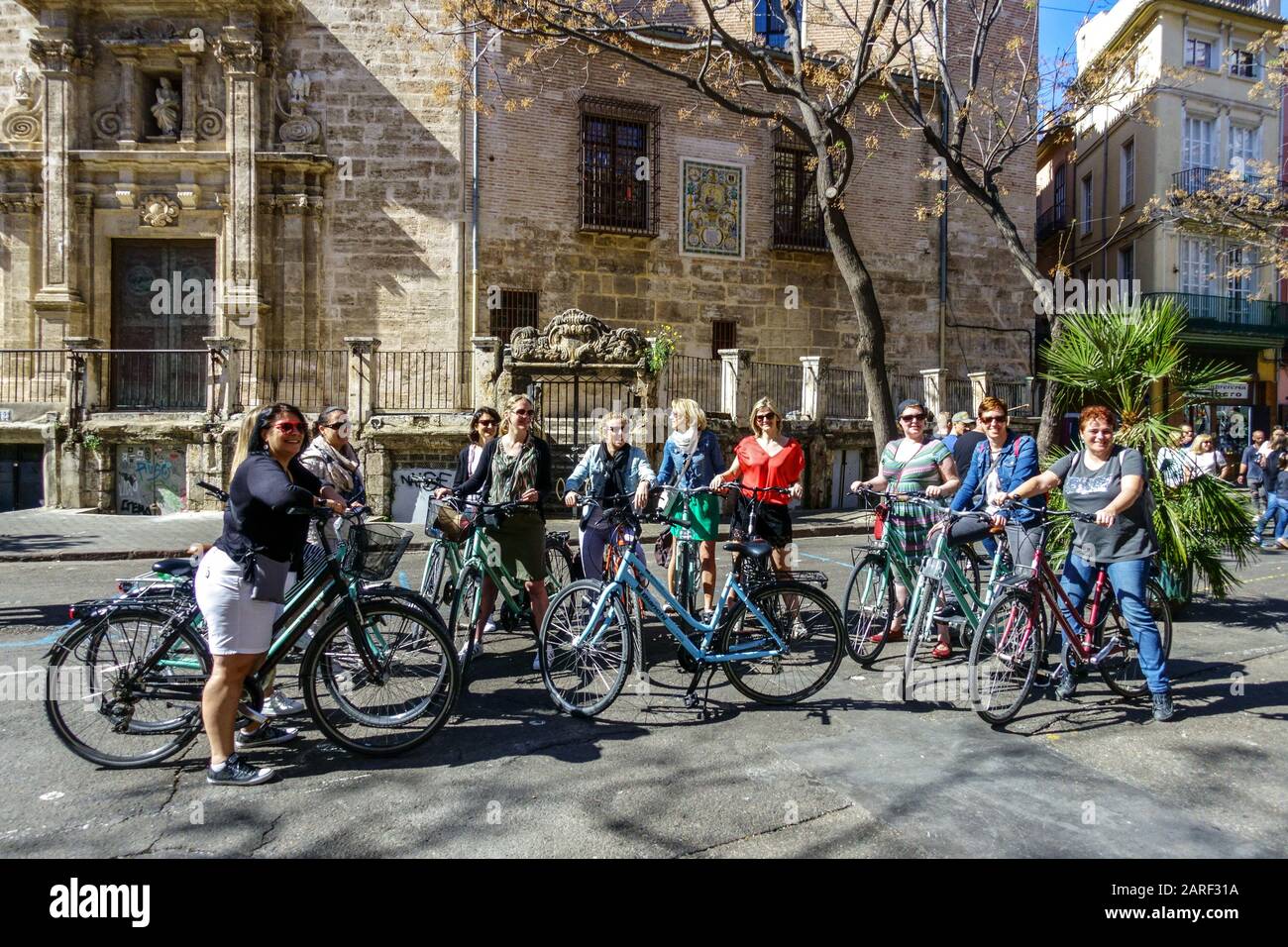 Group of people, women on bikes, Valencia on rental bike Spain cyclist bike cycling Europe street tourists sightseeing Stock Photo