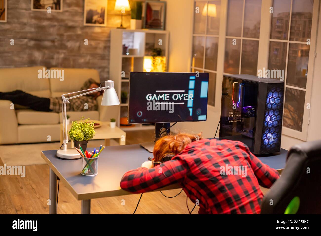 Gamer woman losing at a video game playing late at night in the living room  Stock Photo - Alamy