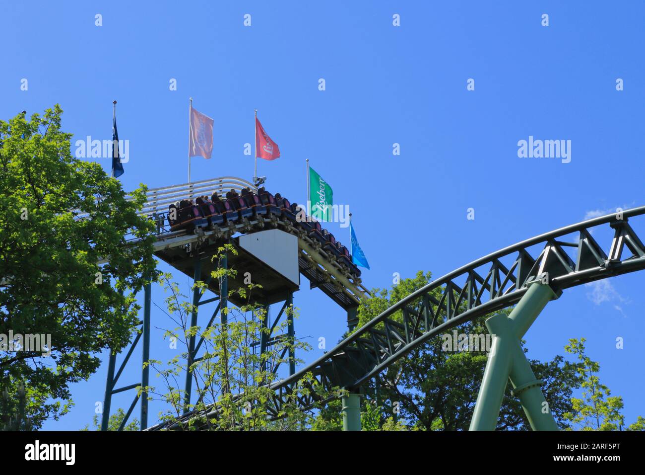 People on a roller coaster train in Liseberg amusement park in Gothenburg city, Sweden. Stock Photo