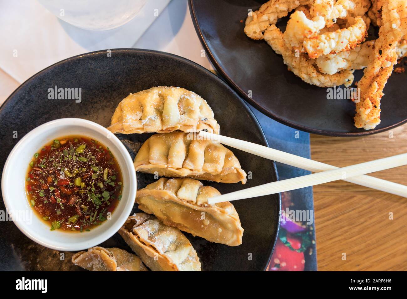 Japanese snacks of fried gyoza and strips of seasoned, crispy squid. Served with a soy, herb and