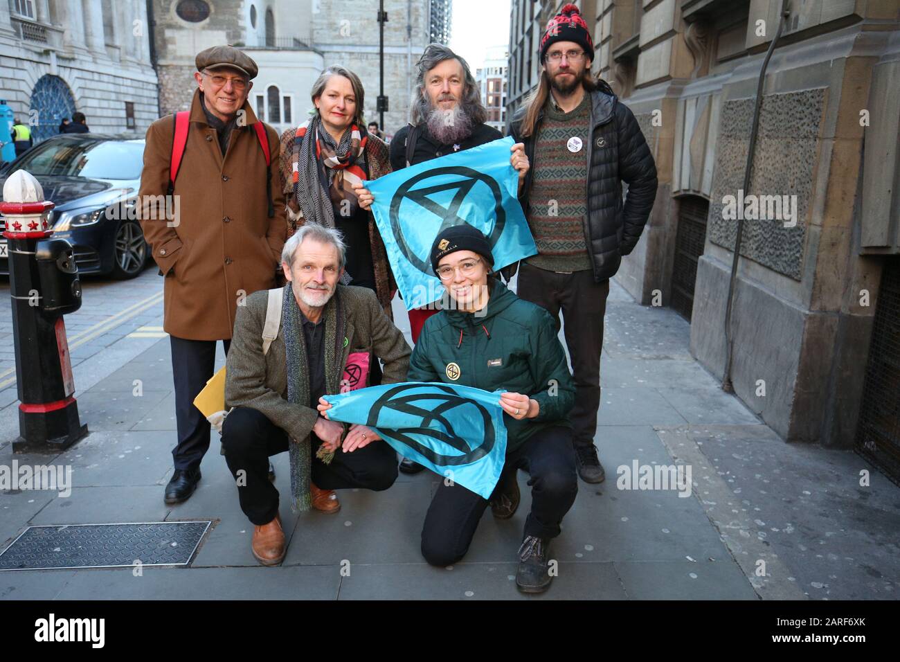 From left to right: Sir David King (back left), Claudia Fisher, 57, a business woman from Brighton, Senan Clifford, 59, a former teacher from Gloucestershire, and Ben Bont ( back right), 42, a tree surgeon from West Wales and David Lambert (front left), 60, a historian from Gloucestershire, Phoebe Valentine (front right), 23, a maths student from Brighton, pose outside the City of London Magistrates' Court, after they were arrested on 10 October 2019, during a peaceful demonstration - in which they glued themselves to the concourse between the DLR station and City Airport in east London. Stock Photo