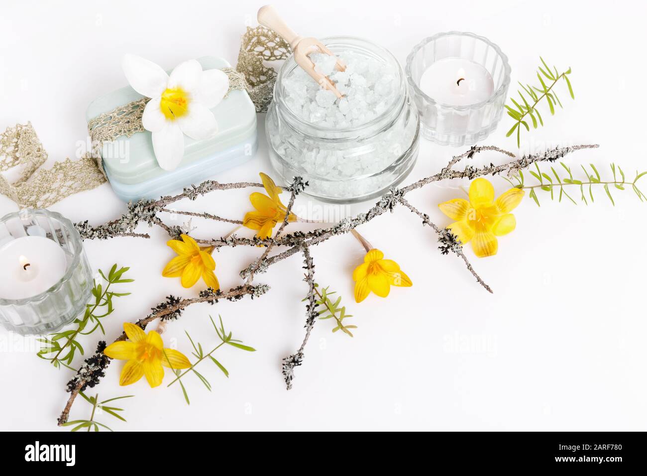 Frame made of branches and yellow spring flowers on white background ...
