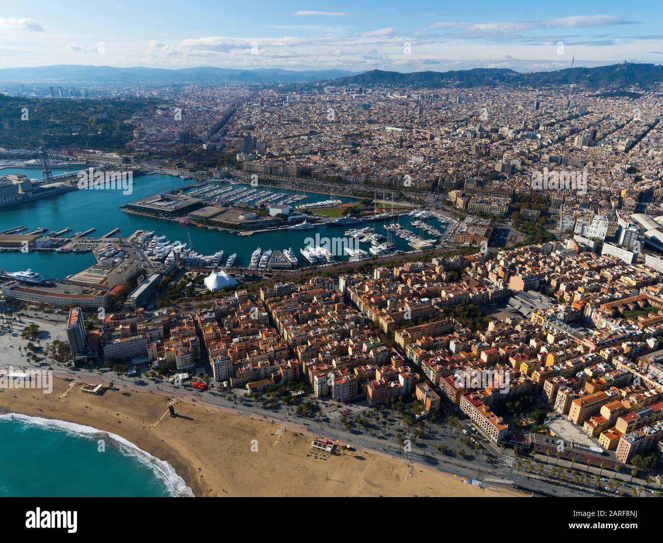 Aerial view of Barcelona with La Barceloneta neighborhoud and recereation port. Stock Photo