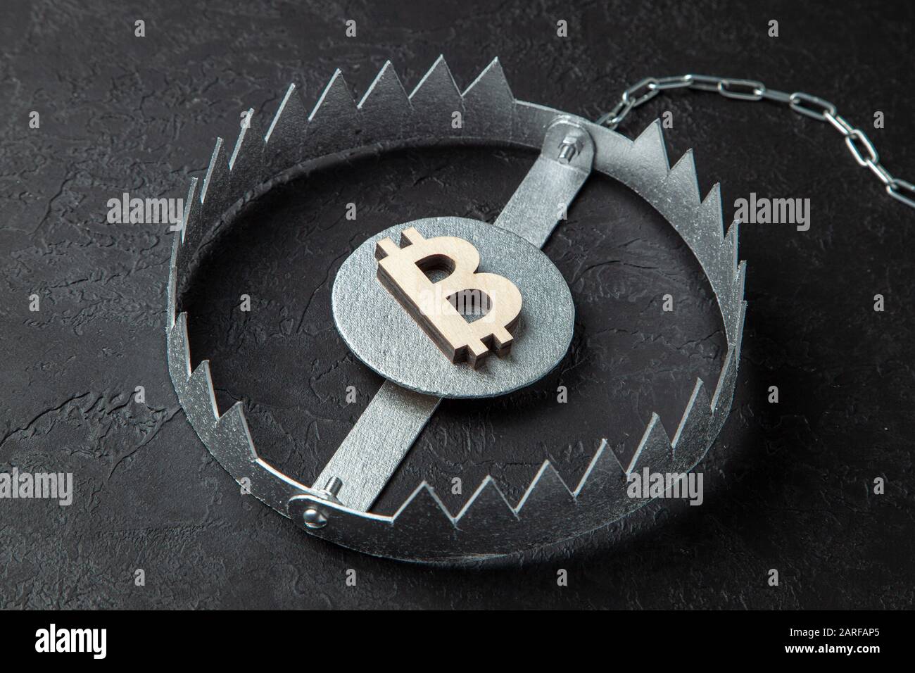 Bitcoin sign in a trap. Cryptocurrency is a trap for money. Stock Photo