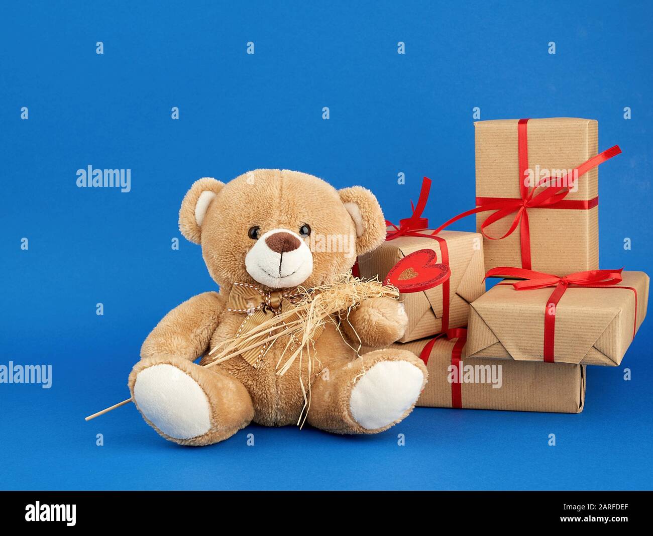 Small beige teddy bear sitting hi-res 