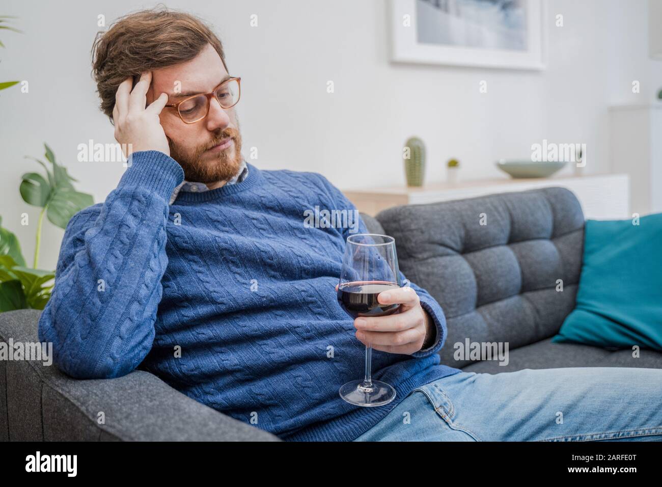 Sad depressed addicted drunk guy having problem Stock Photo