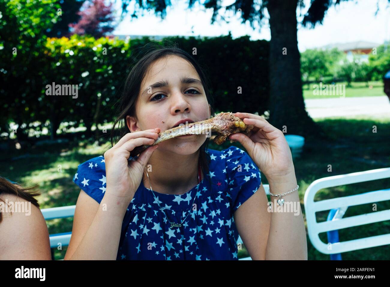 little girl eating ribs funny hungry baby girl eats smoked sausage and pork ribs in ...
