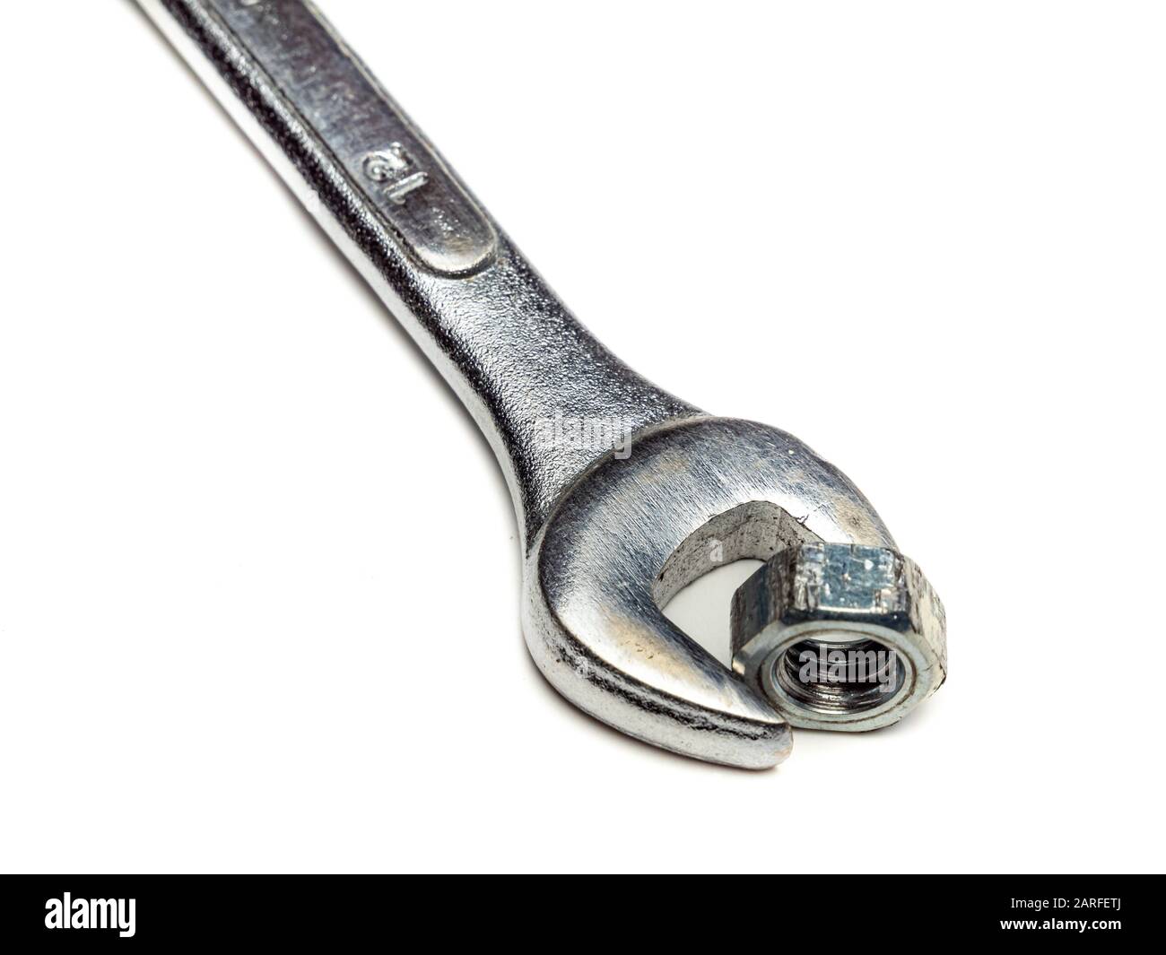 Wrench with nut isolated on white background Stock Photo - Alamy