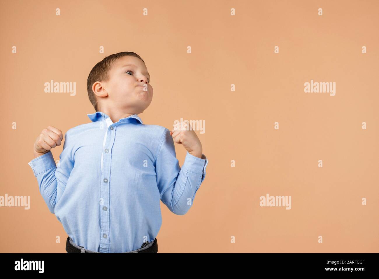 proud little child boy on beige background. Human emotions and facial  expression. copy space Stock Photo - Alamy