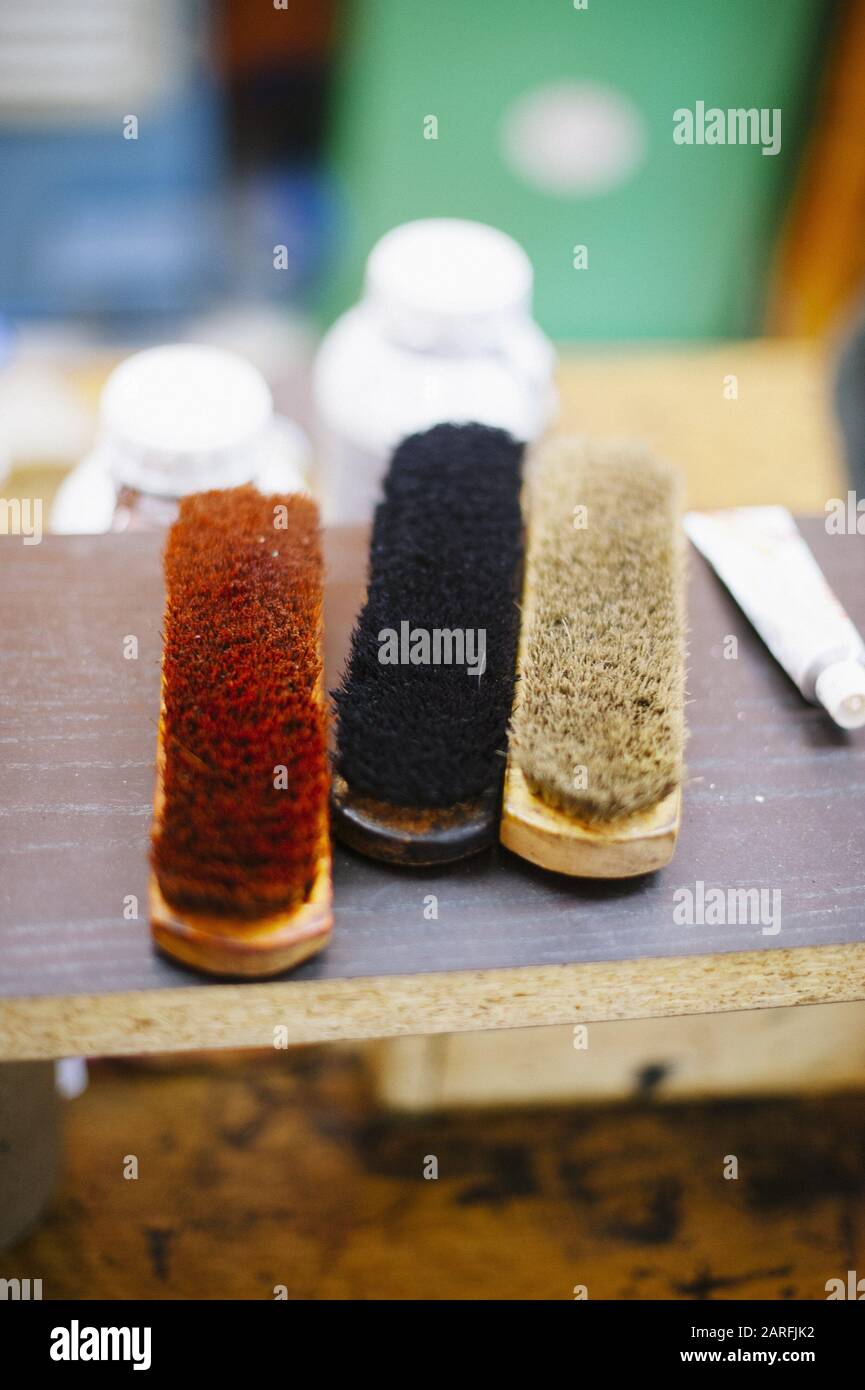 Cobbler brushes to polish shoes Stock Photo Alamy
