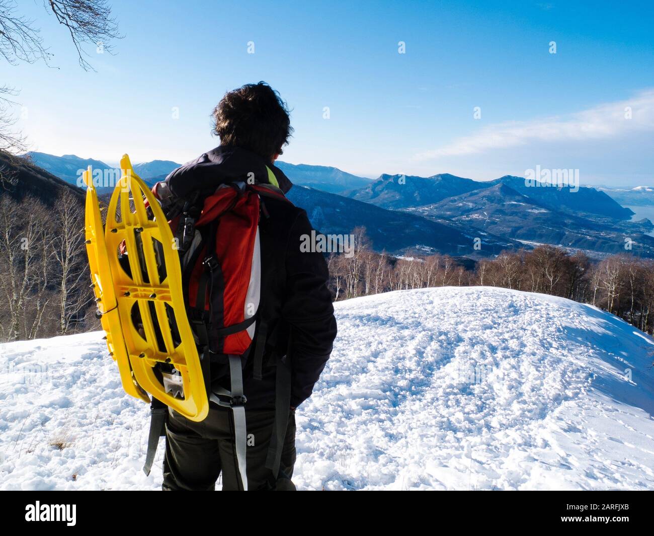 Hiking with snowshoes hanging backpack, view the landscape Stock Photo Alamy
