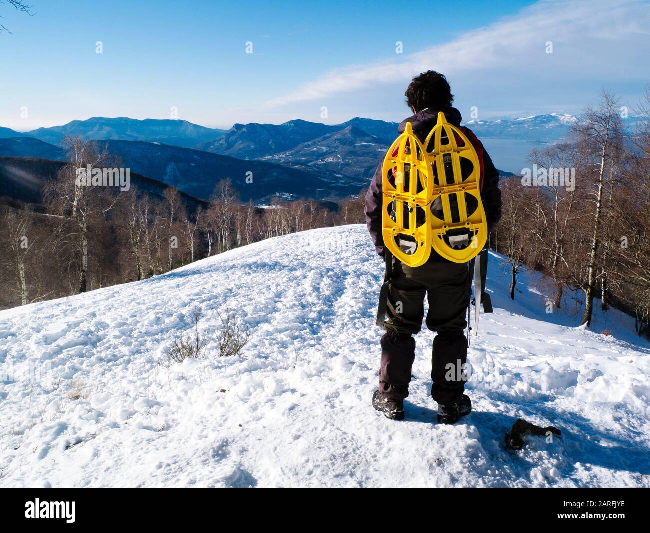 Hiking with snowshoes hanging backpack, view the landscape Stock Photo Alamy