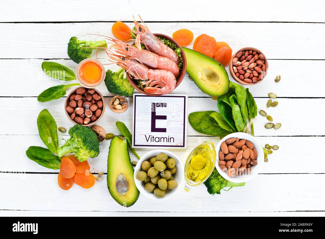 Food containing natural vitamin E: Spinach, parsley, shrimp, pumpkin seeds,  eggs, avocados, broccoli. Top view. On a white wooden background Stock  Photo - Alamy