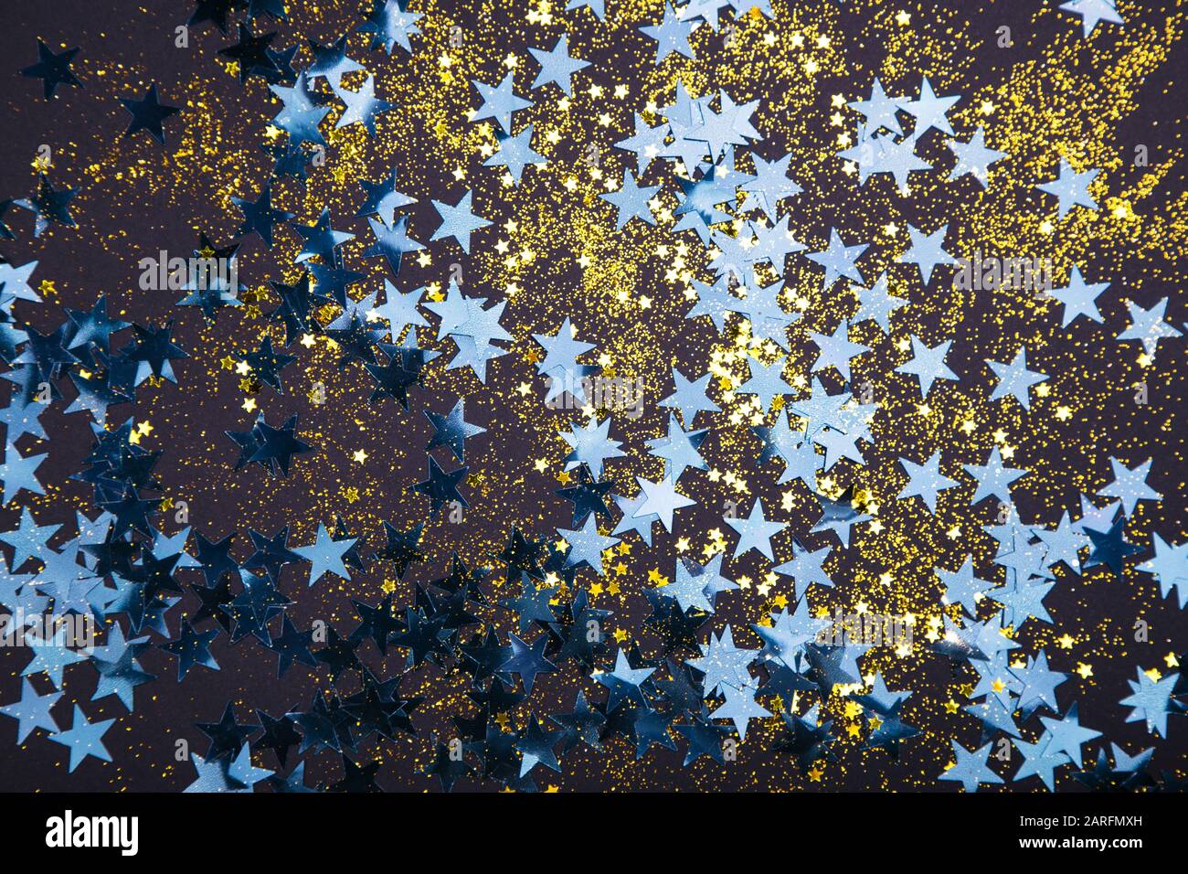Holiday background with little blue stars and golden glitter Stock Photo Alamy
