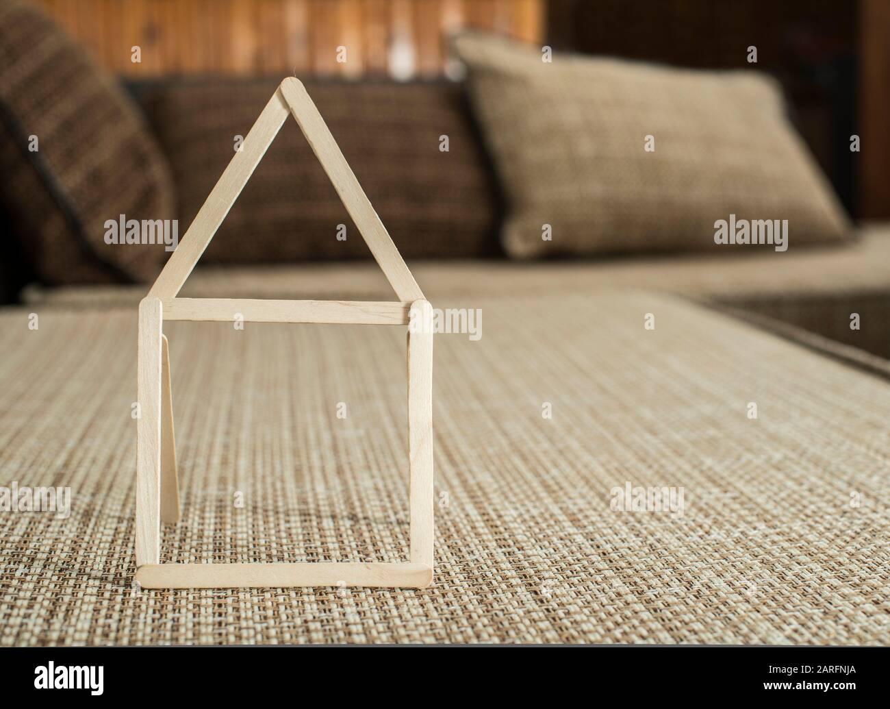 Model house made of wooden sticks placed in room interior Stock Photo -  Alamy