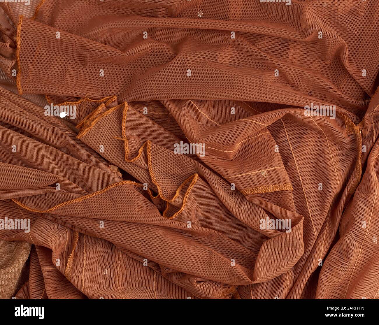 crumpled brown tulle, fabric for sewing clothes, full frame, close up. Stock Photo