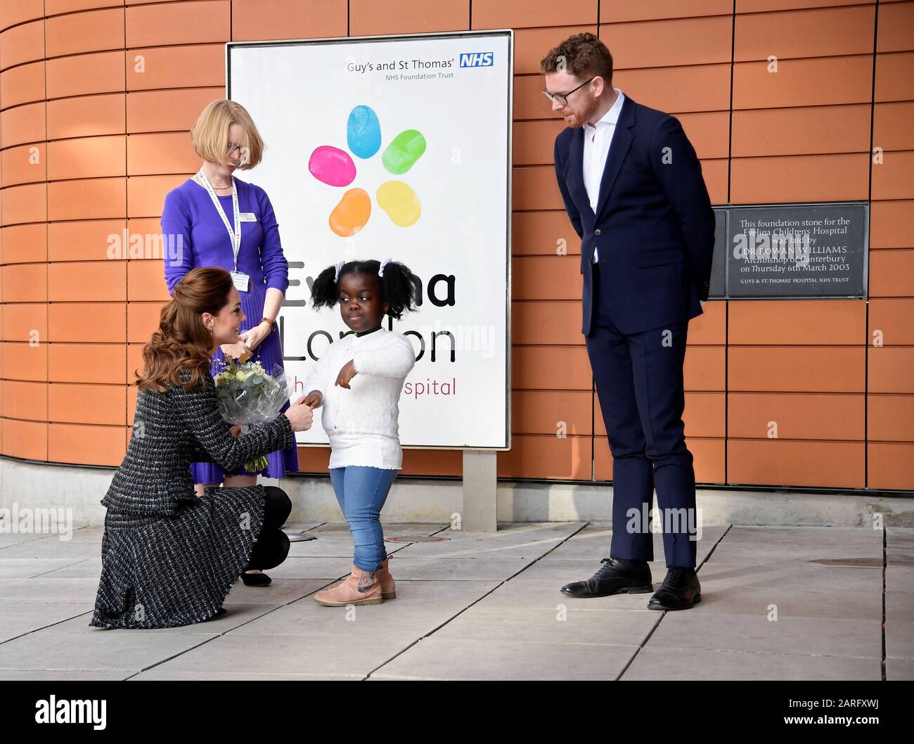 The Duchess of Cambridge, presented with flowers by a patient, as she arrives to visit a creative workshop run by the National Portrait Gallery's Hospital Programme at Evelina London Children's Hospital, within St Thomas' Hospital, Westminster, London. PA Photo. Picture date: Tuesday January 28, 2020. See PA story ROYAL Cambridge. Photo credit should read: Toby Melville/PA Wire Stock Photo
