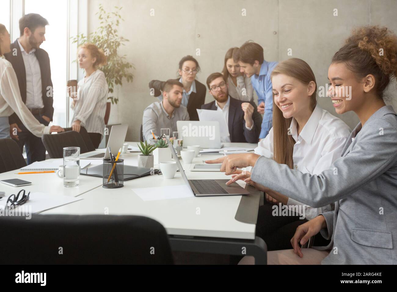 Groups of colleagues having break at meeting, using gadgets Stock Photo