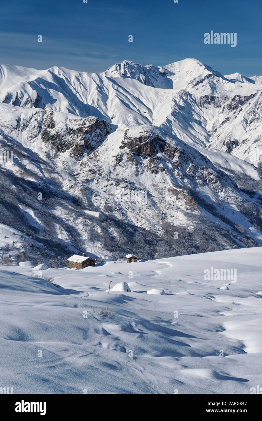 Snow covered barns on the slopes above the French ski resort of St Martin de Belleville in the 3 valleys Stock Photo