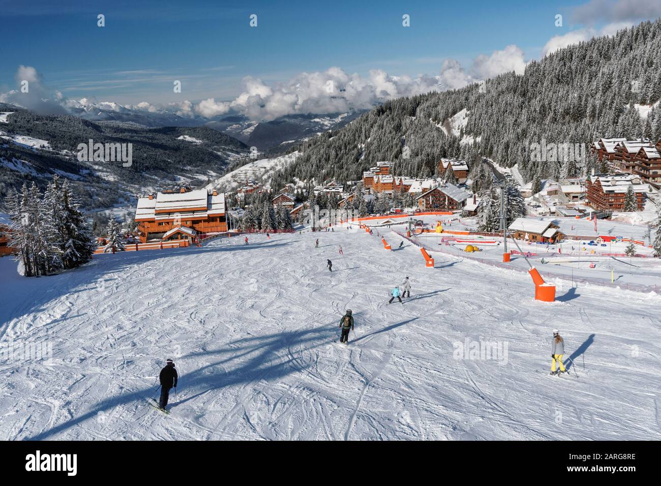 Skiing in the French resort of Meribel in the three valleys, shot from the Rhodos telecabine looking down over pistes and chalets at Rond Point Stock Photo