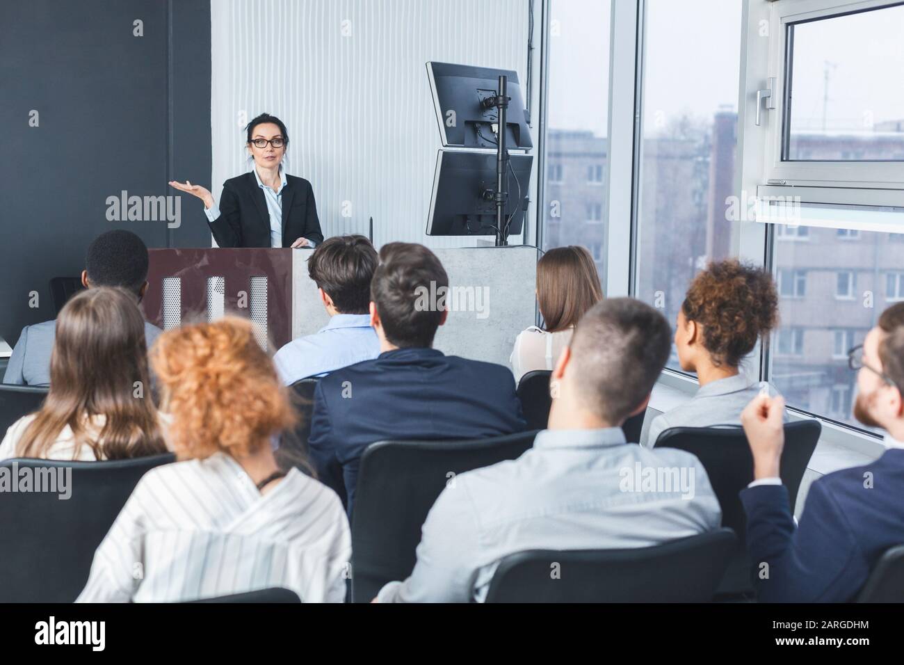 Business lecture. Coach giving presentation to young staff Stock Photo