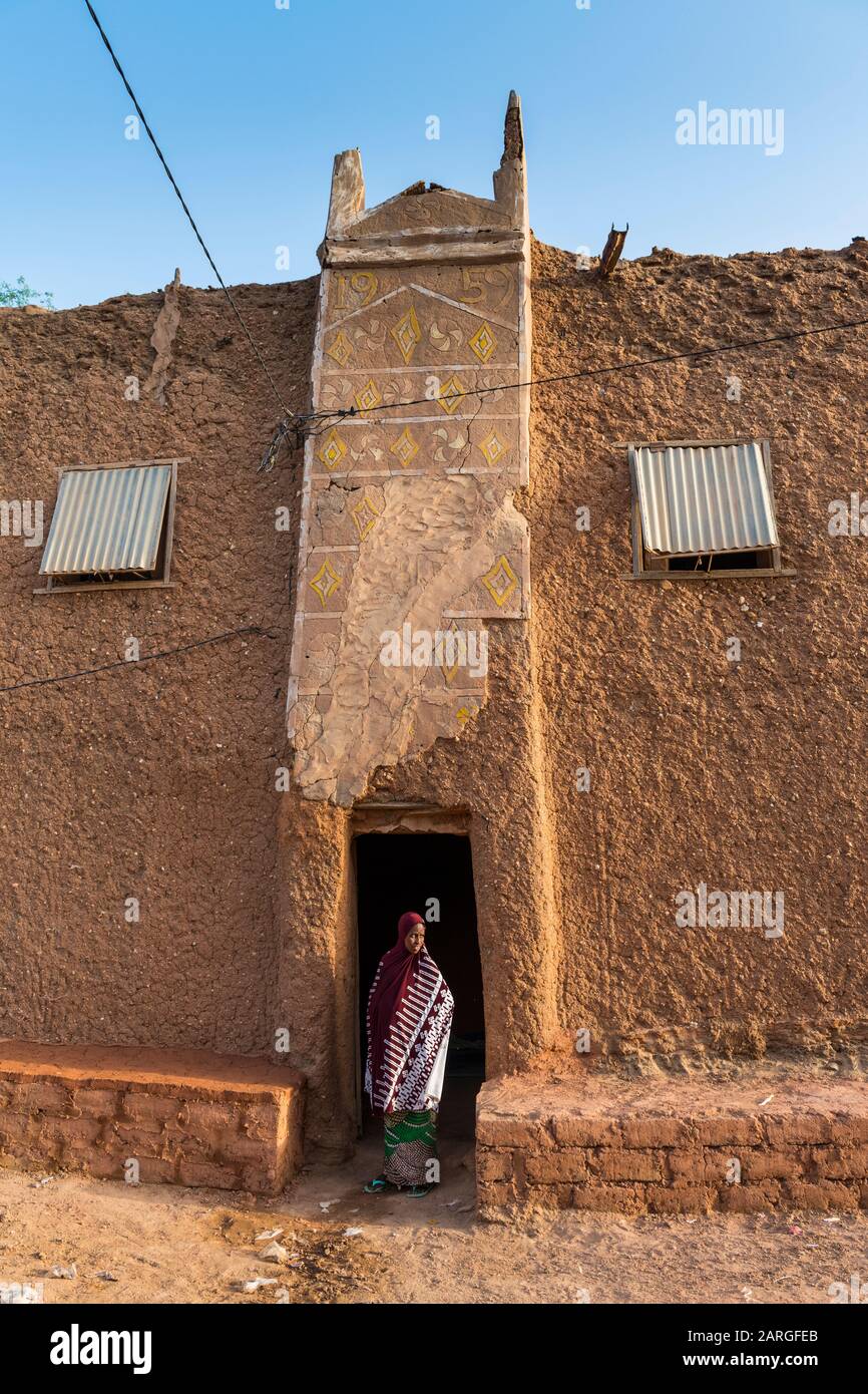Young girl in front of a traditional house, UNESCO World Heritage Site, Agadez, Niger, West Africa, Africa Stock Photo