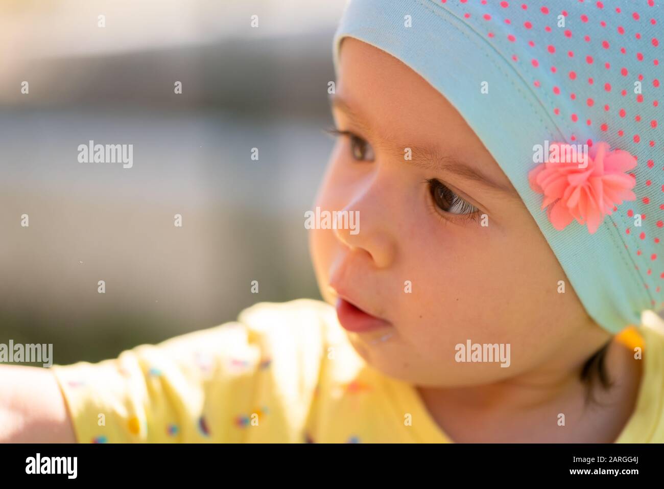 Portrait of very sweet little child with big eyes. 1 year old baby girl Stock Photo