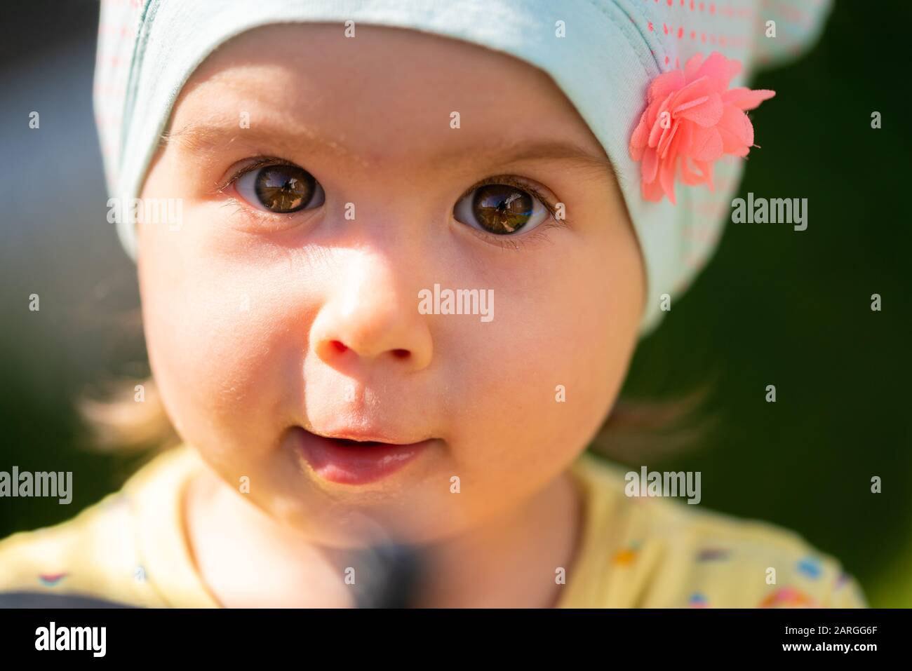 Portrait of very sweet little child with big eyes. 1 year old baby girl Stock Photo