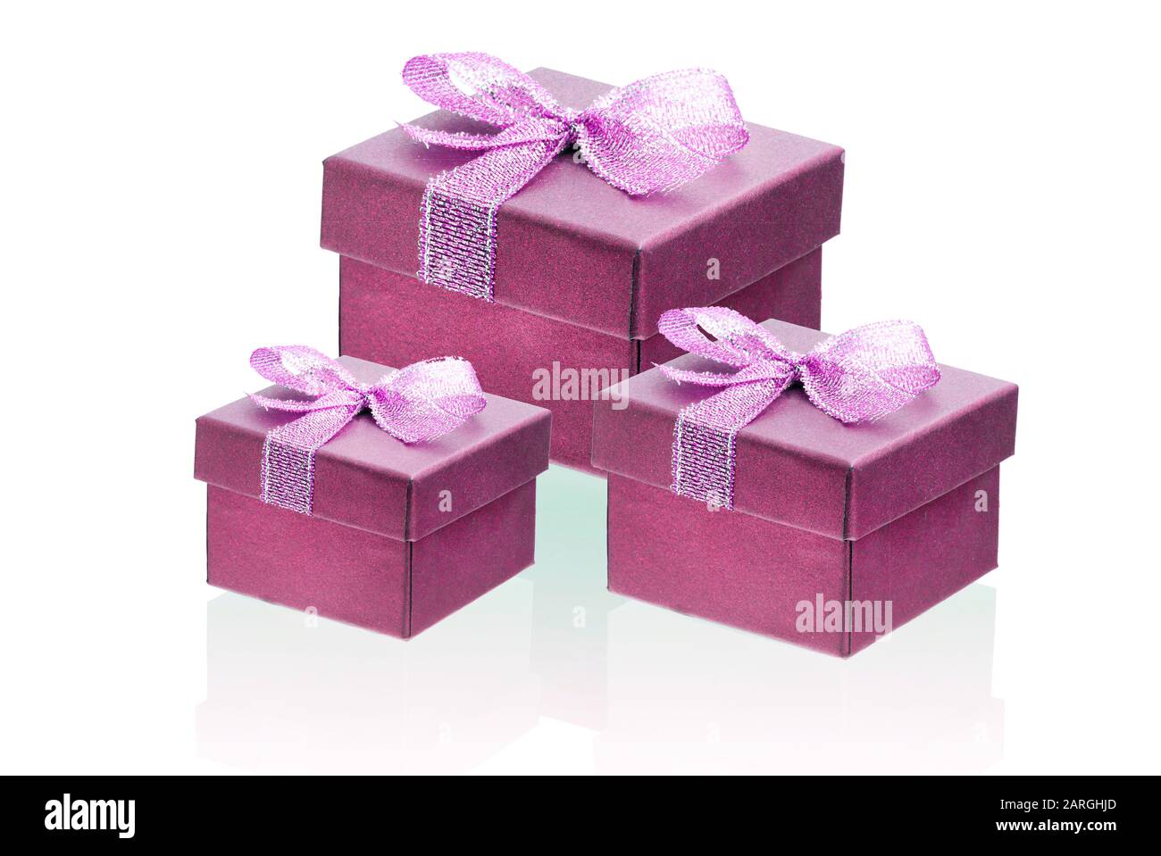 Three red gift boxes isolate on a white background, close-up. Stock Photo