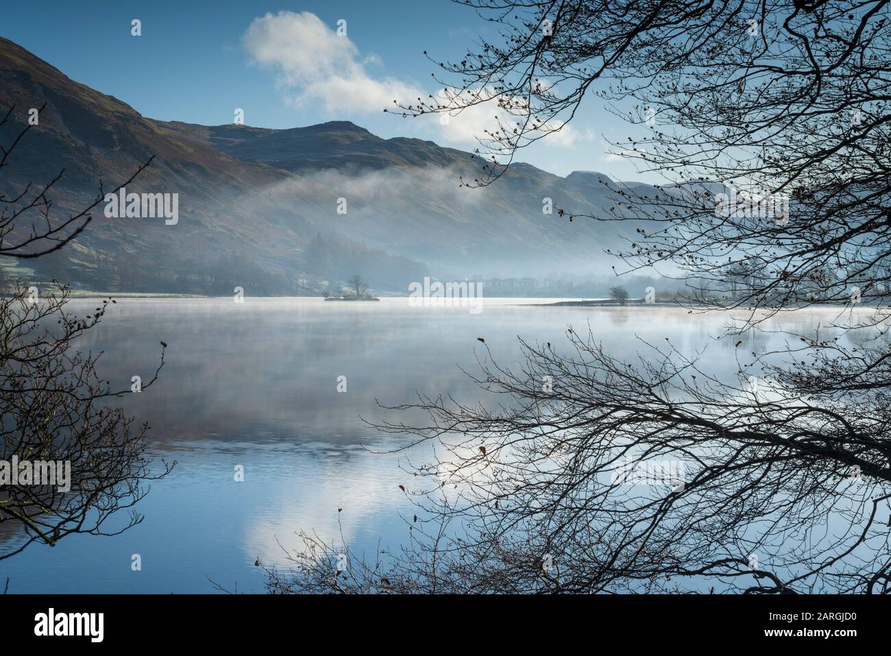 Dawn light and transient sunlit mist over Wall Holm Island on Ullswater, Lake District National Park, UNESCO World Heritage Site, Cumbria, England, UK Stock Photo