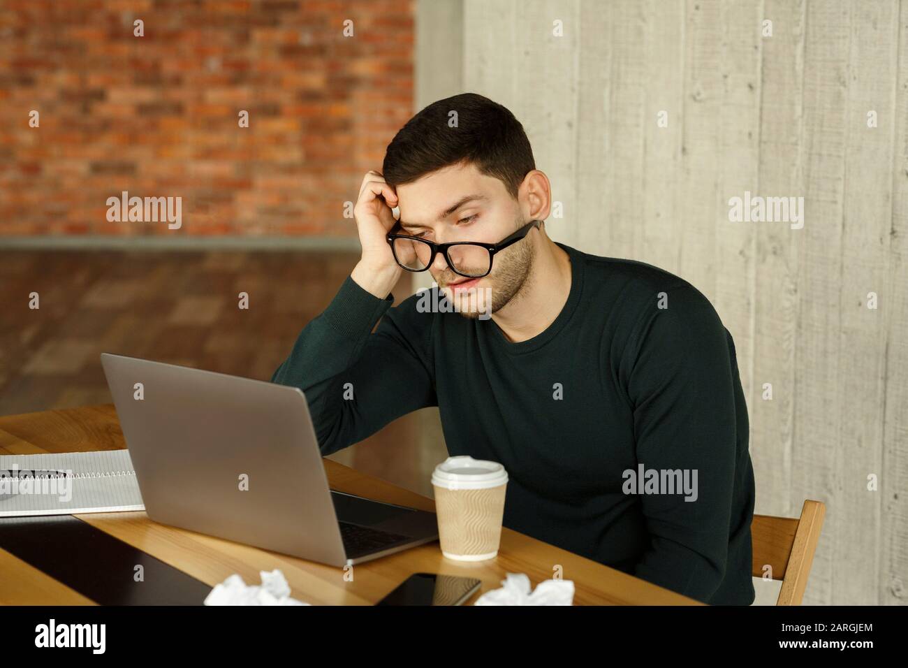 Overworked Guy Sleeping At Workplace Sitting At Laptop In Office Stock Photo