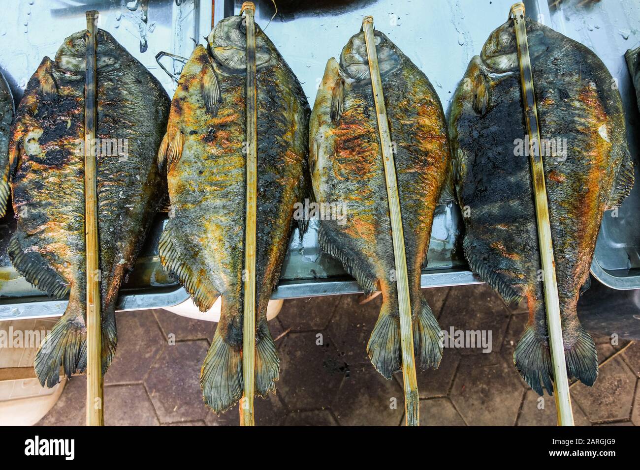 Fish barbecued with sticks at a stall in the Crab Market in this resort town famous for its seafood, Kep, Cambodia, Indochina, Southeast Asia, Asia Stock Photo