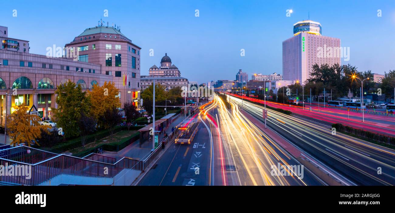 Traffic trail lights on major road near Beijing Zoo at dusk, Beijing, People's Republic of China, Asia Stock Photo