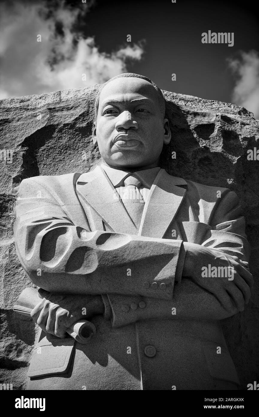 WASHINGTON DC - AUGUST, 2018: Dr Martin Luther King, Jr carved from stone at the memorial in his name stands with arms crossed in black and white. Stock Photo
