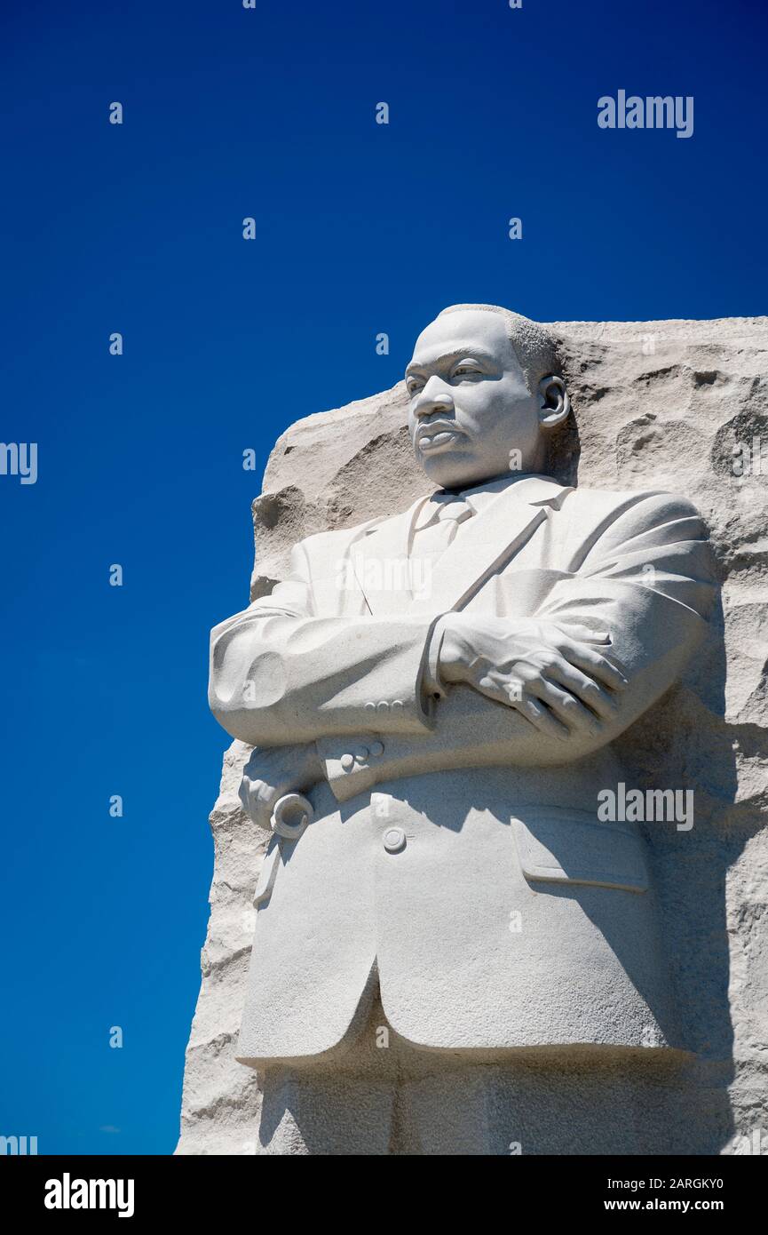WASHINGTON DC - AUGUST, 2018: The portrait of Dr Martin Luther King, Jr carved from white stone at the memorial in his name stands with arms crossed. Stock Photo