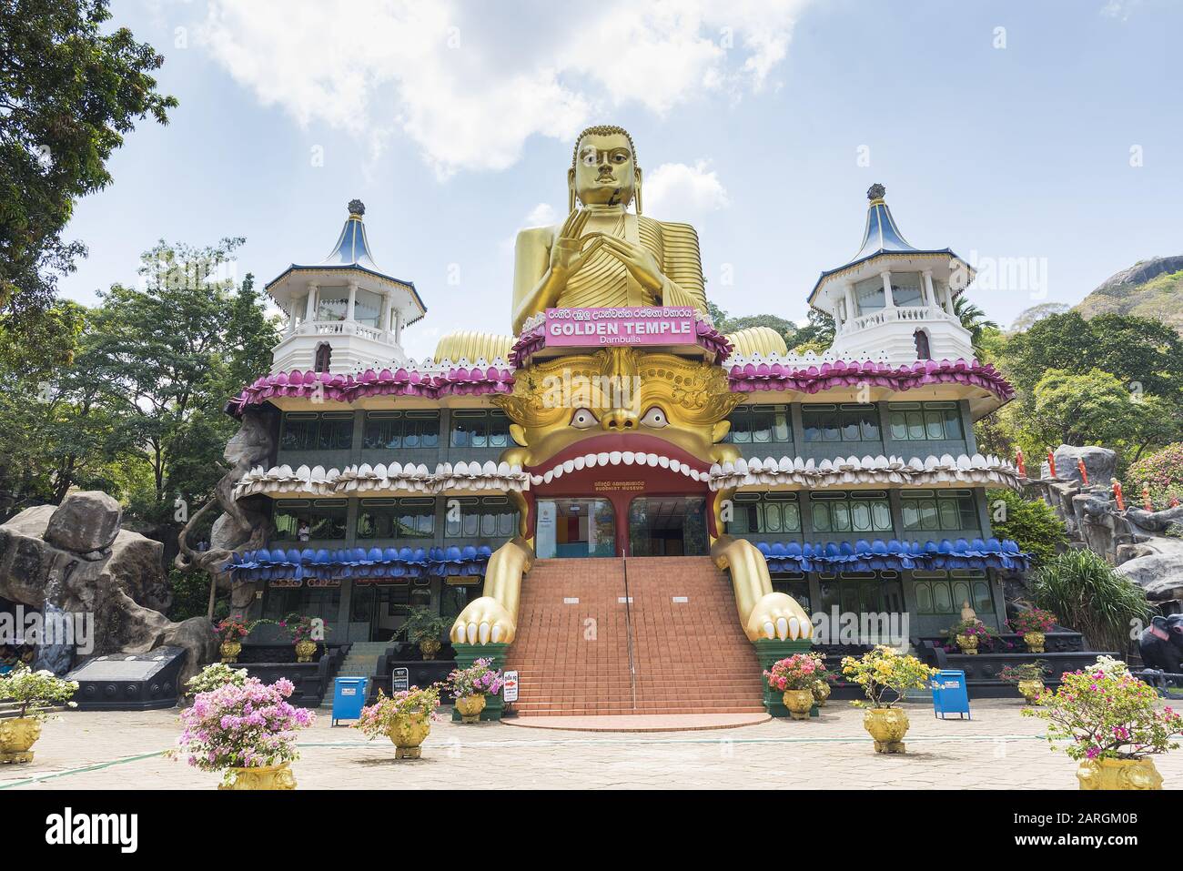 Dambulla, Sri Lanka: The Golden Temple main facade of the Buddhist Museum showing the approach to the visitor entrance. World heritage sit Stock Photo