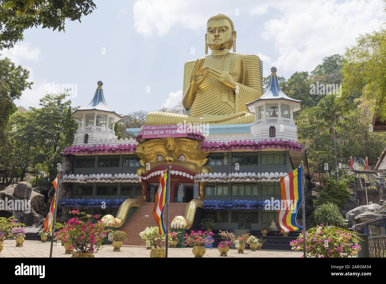 Dambulla, Sri Lanka:  The Golden Temple main facade of the Buddhist Museum showing the approach to the visitor entrance. World heritage sit Stock Photo